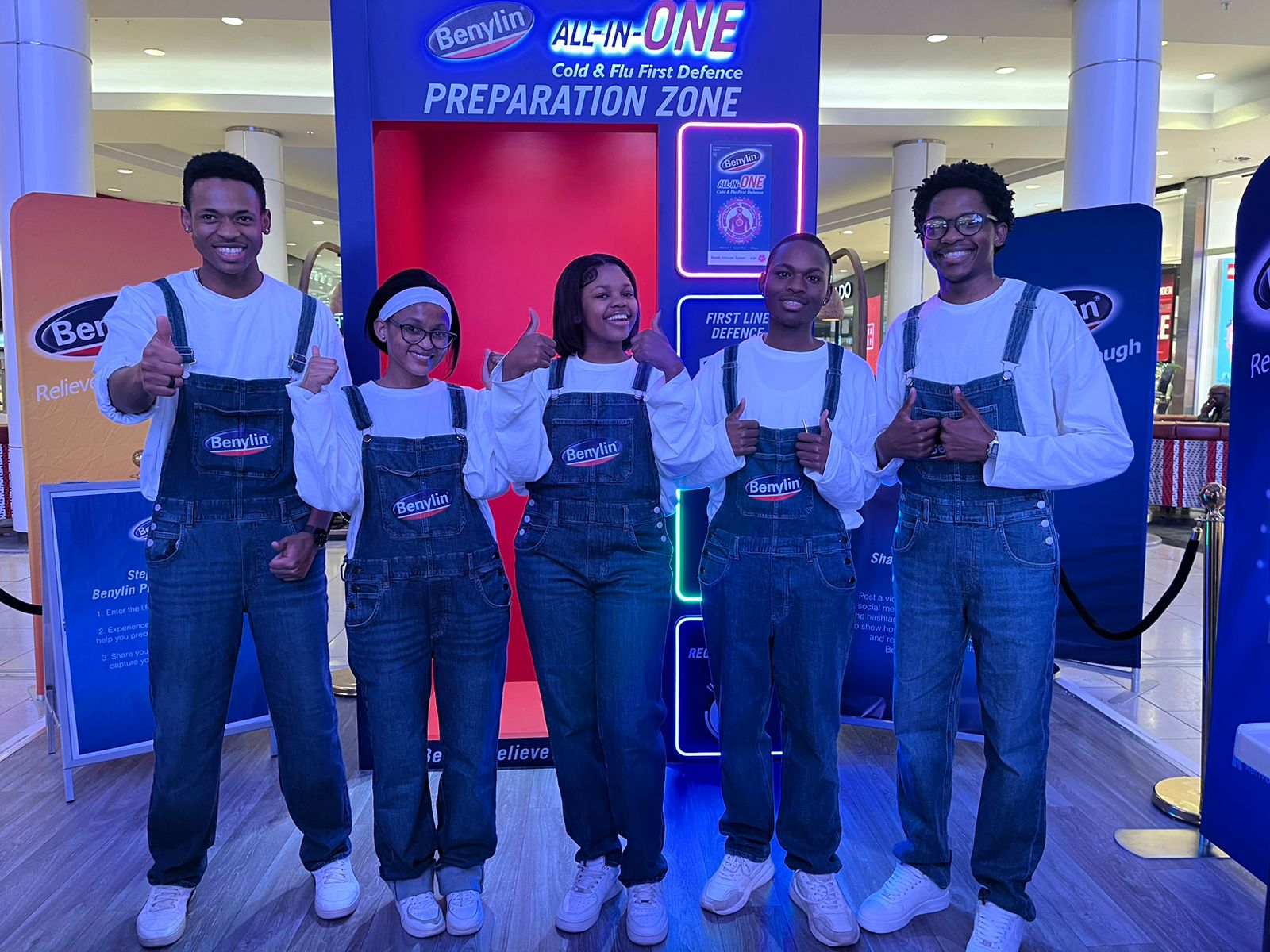 Promoters in Benylin branded denim overalls at a mall activation