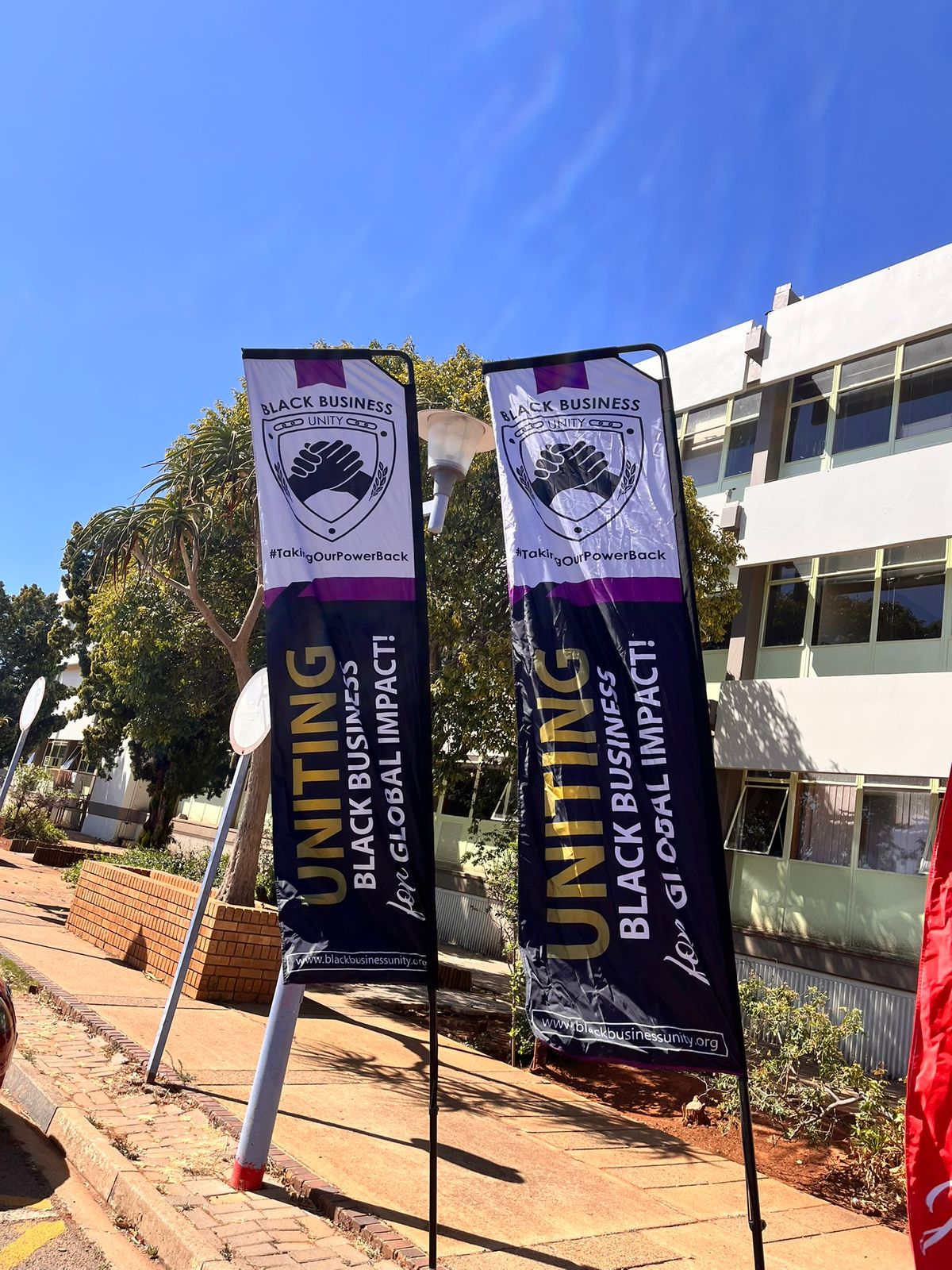 Black Business Unity feather banners outdoors