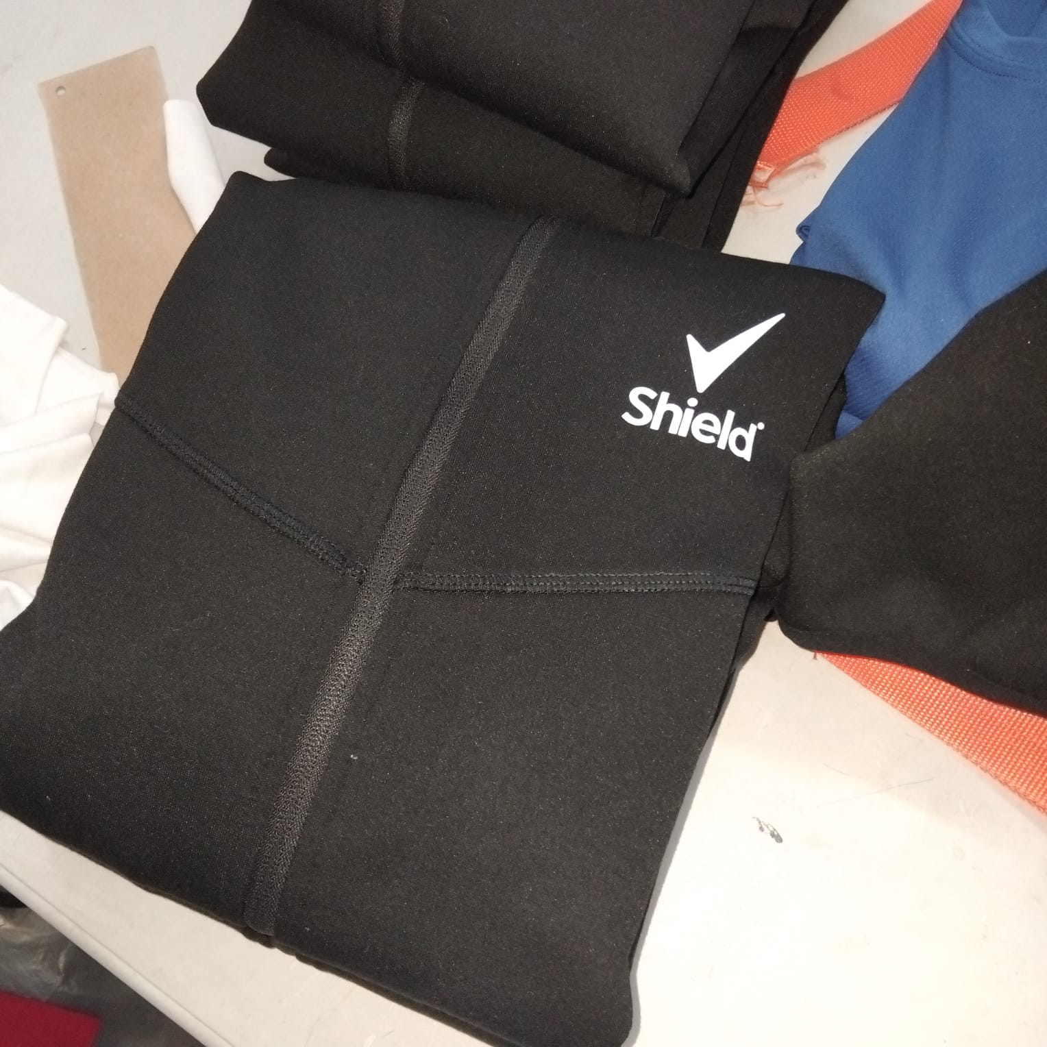 Shield branded black neoprene gear